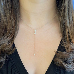 Female Model Wearing Diamond Halos Lariat Necklace 14K gold weighing 2.2 grams - 0.29 cts round diamonds