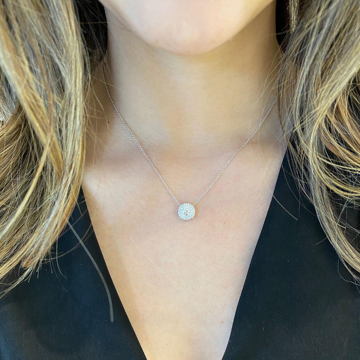 Female Model WearingDiamond Double Halo Pendant Necklace  -18K white gold weighing 4.25 grams  -30 round pave-set diamonds totaling 0.48 carats