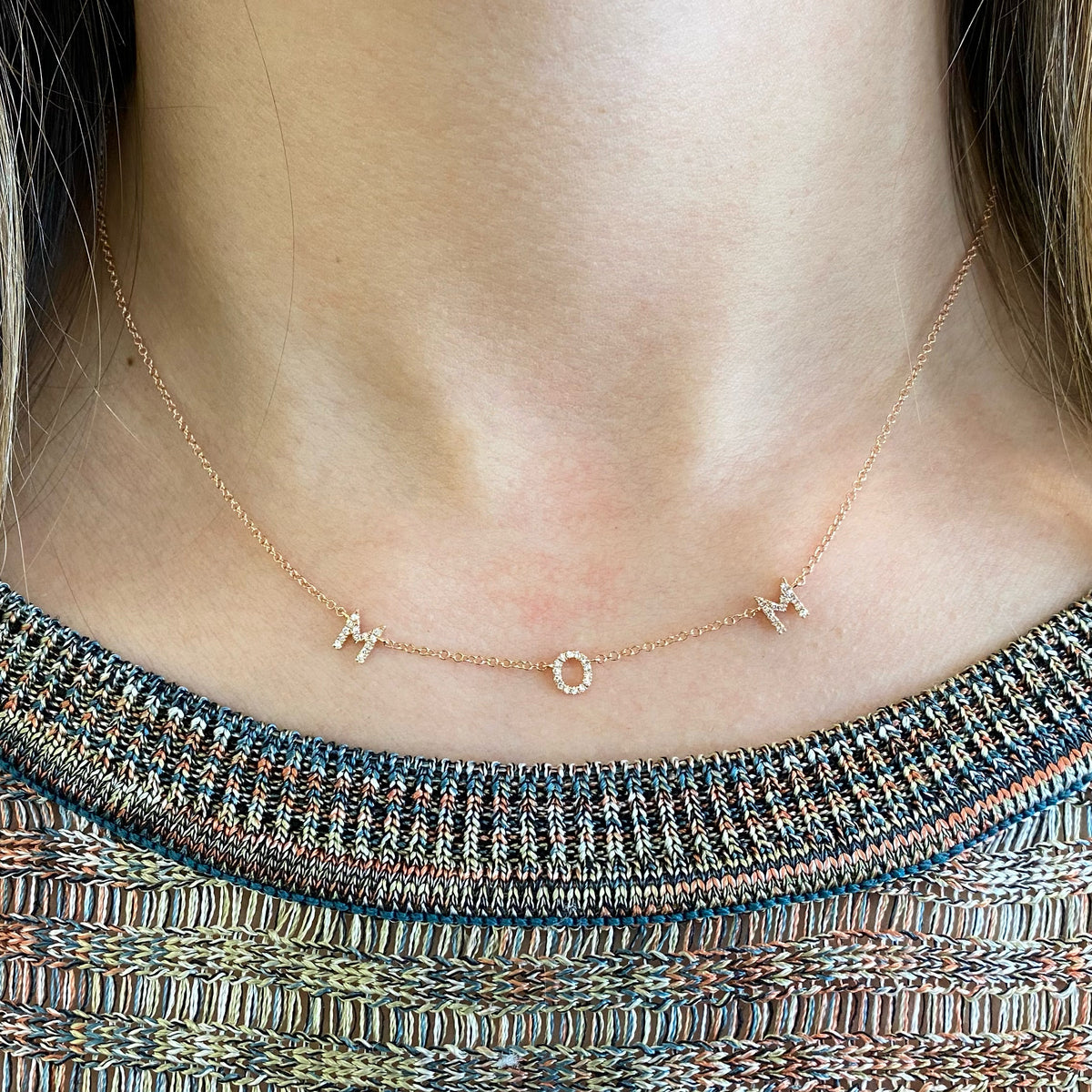 Female Model Wearing Diamond Mom Necklace  -14k gold weighing 1.68 grams  -40 round diamonds weighing .09 carats