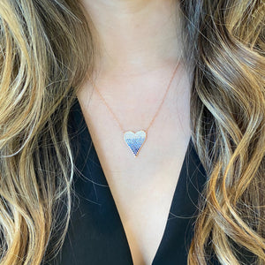 Female model wearing Sapphire Gradient Heart Pendant - 14K gold weighing 3.25 grams - 6 round diamonds totaling 0.07 carats - 89 sapphires totaling 1.02 carats