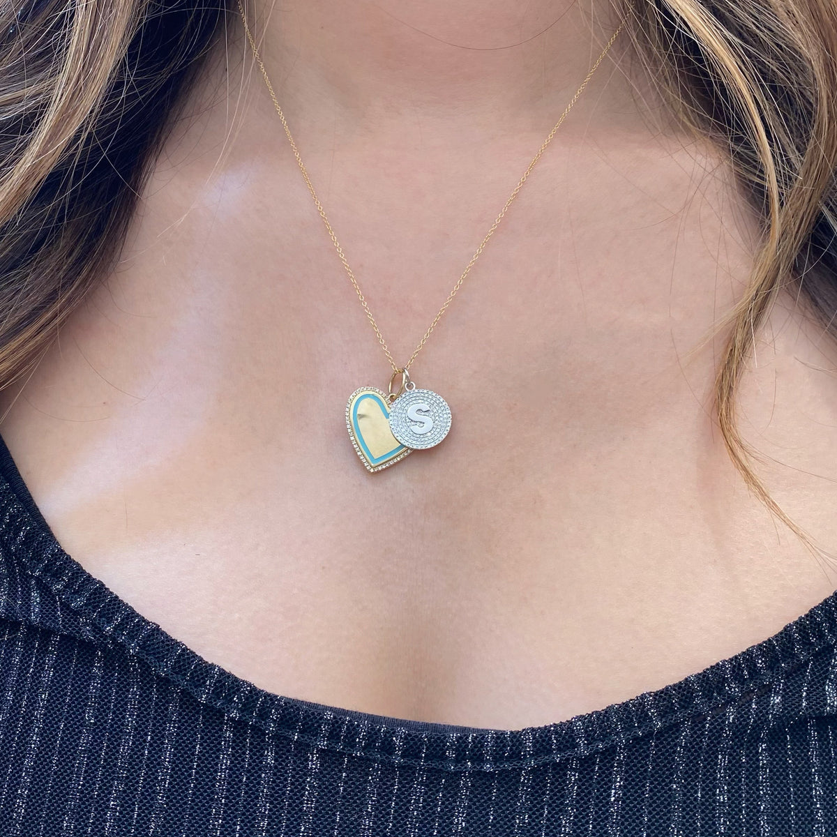 Female model wearing Diamond & Enamel Heart Pendant - 14K gold weighing 6.51 grams - 62 round diamonds totaling 0.16 carats