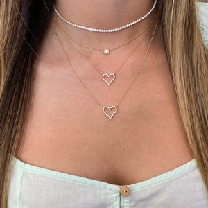 Female Model Wearing Diamond Small Open Heart Necklace  - 14K gold weighing 1.98 grams  - 24 round diamonds totaling 0.25 carats