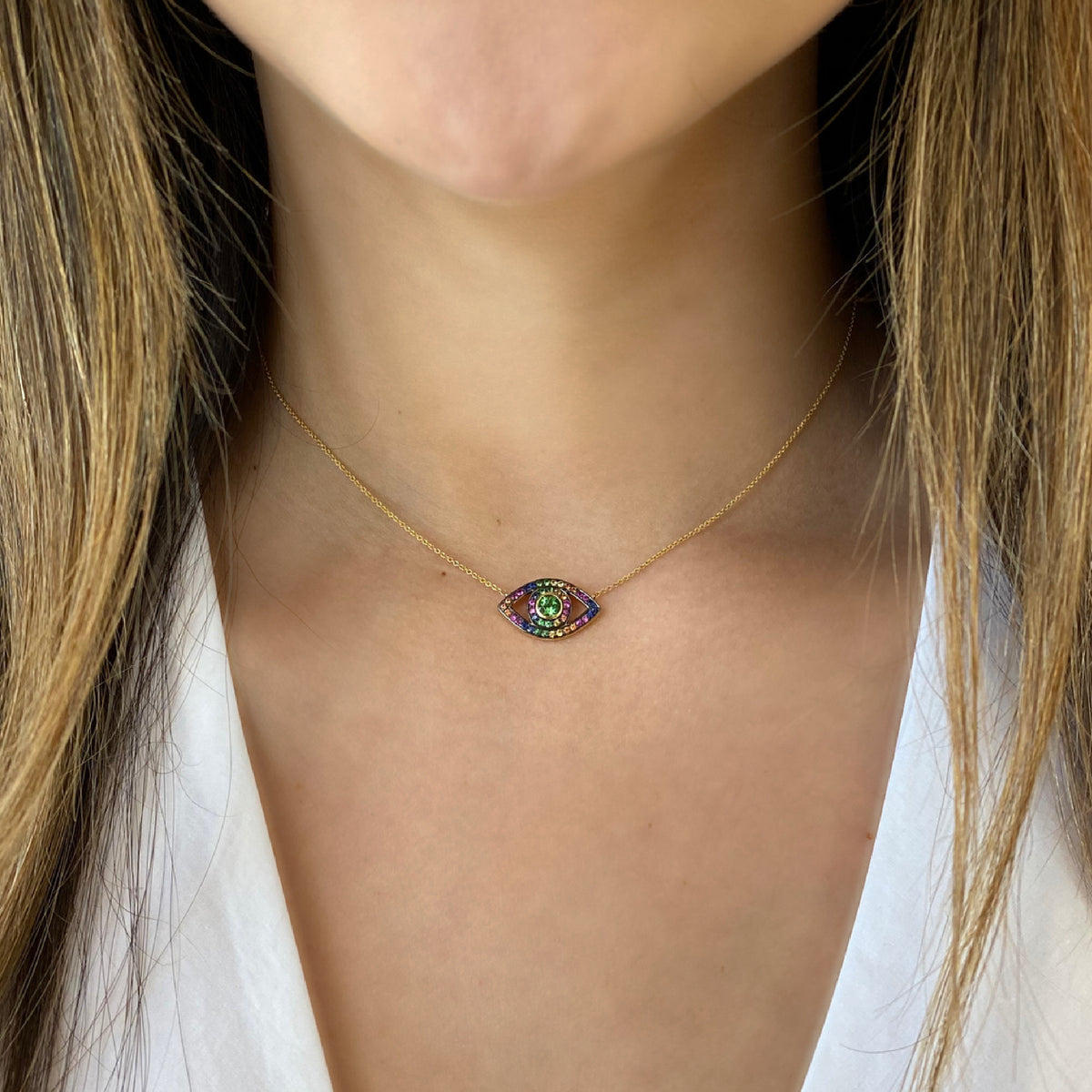 Female Model Wearing Multicolor Gemstone Evil Eye Necklace  -14K gold weighing 2.79 grams  -45 multicolor gemstones weighing 0.65 carats