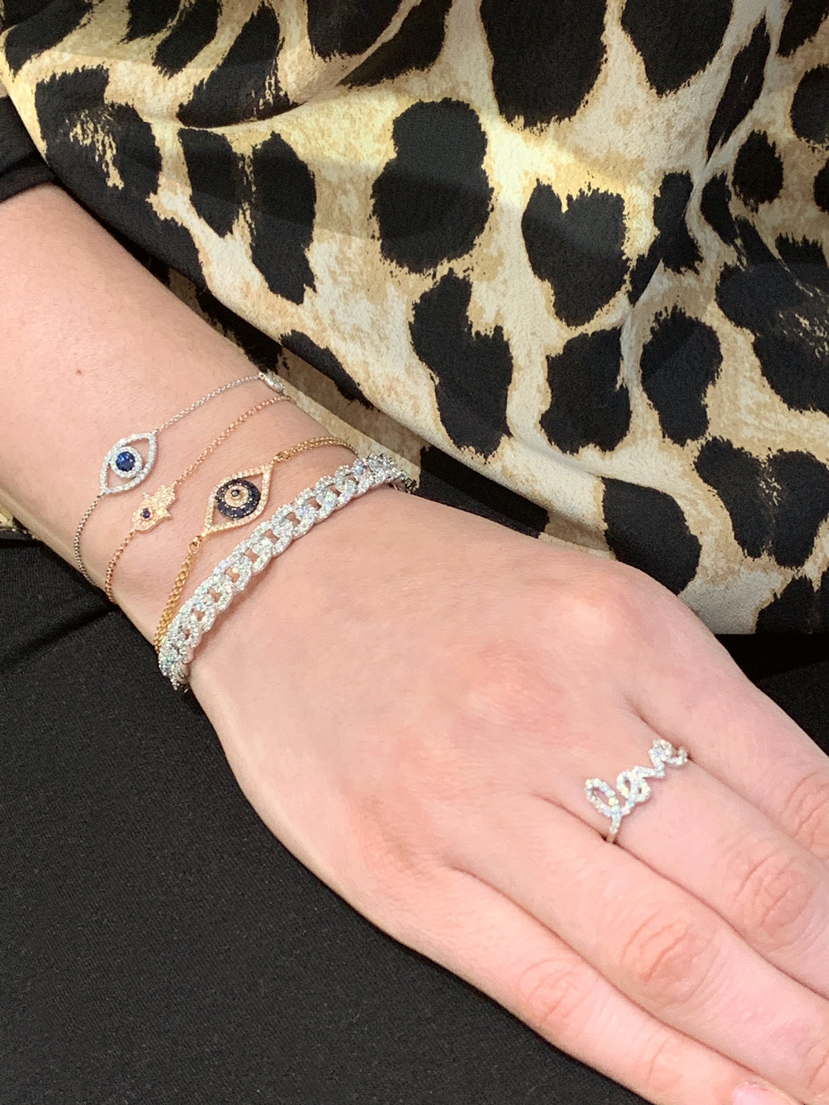 Female model wearing Diamond Small Link Cuff Bracelet -14K gold weighing 13.86 grams -153 round diamonds totaling 1.64 carats