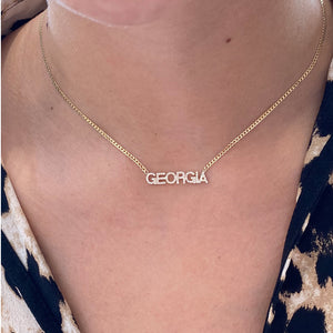 Female Model Wearing Diamond Name Curb Chain Necklace  - 14K gold weighing 4.52 grams  - 68 round diamonds totaling 0.22 carats