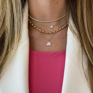 Female Model Wearing Diamond Heart Shape Pendant - 14K gold weighing 2.23 grams  - 90 round diamonds totaling 0.20 carats