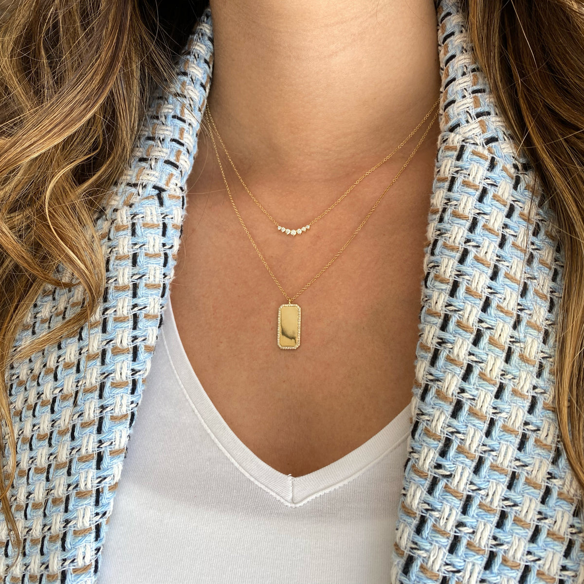 Female Model Wearing Diamond Framed Dog Tag Pendant  - 14K gold weighing 3.40 grams  - 50 round diamonds totaling 0.15 carats