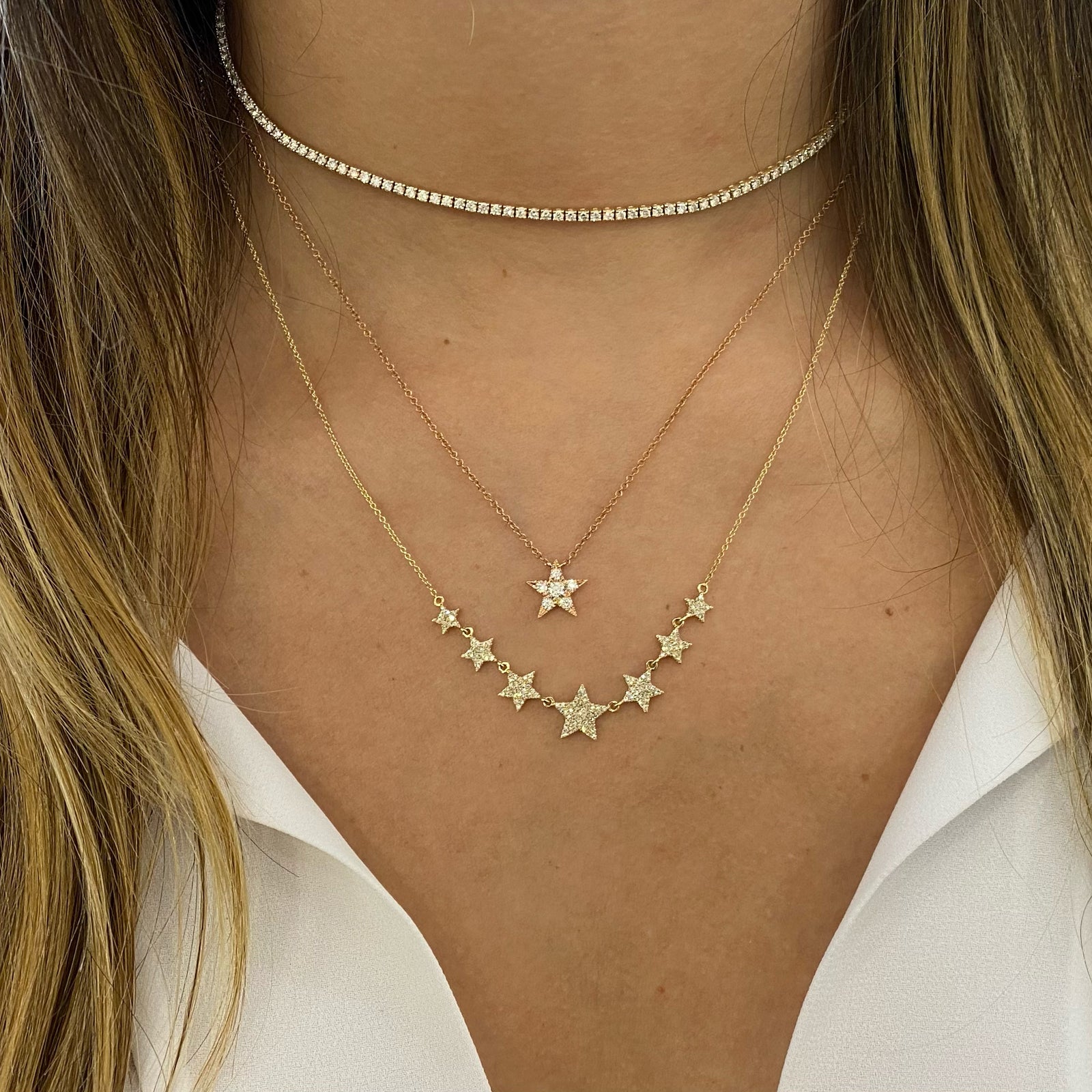 Diamond Twinkling Star Pendant  - 14K gold weighing 1.71 grams  - 6 round diamonds totaling 0.22 carats
