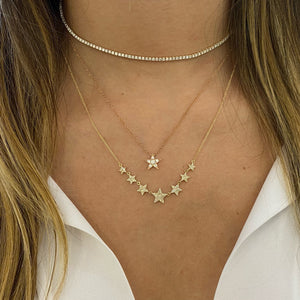 Female Model Wearing Diamond Twinkling Star Pendant  - 14K gold weighing 1.71 grams  - 6 round diamonds totaling 0.22 carats