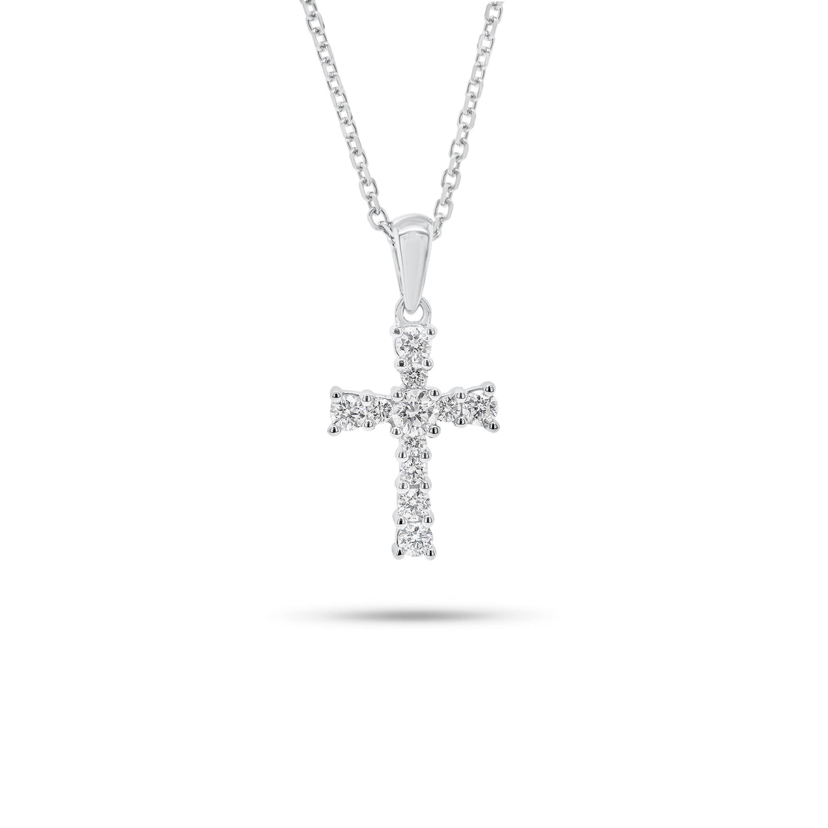 Graduated Diamond Cross Pendant - 18K gold weighing 0.91 grams  - 14K gold weighing 1.60 grams  - 11 round diamonds weighing 0.28 carats