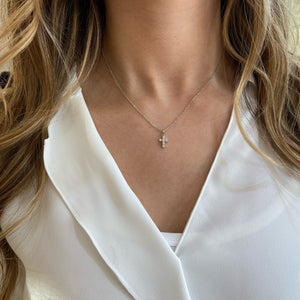 Female Model Wearing Diamond 6-Stone Cross Pendant Necklace  18K totaling .69 GR  6 rounds diamonds .31 ct