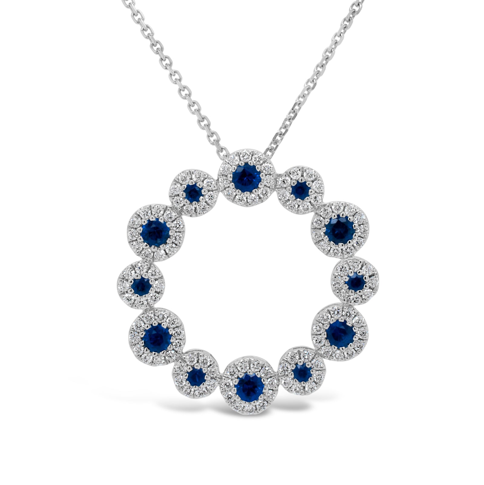 Sapphire & Diamond Wreath Pendant  - 18K gold weighing 3.21 grams  - 14K gold weighing 1.60 grams  - 114 round diamonds totaling 0.52 carats  - 12 sapphires totaling 0.77 carats