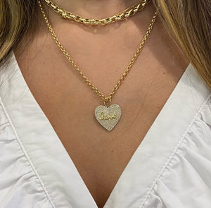 Female model wearing Diamond Love Heart Pendant - 14K gold weighing 2.92 grams - 279 round diamonds totaling 0.83 carats