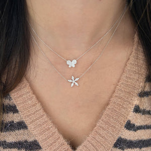 Female Model Wearing Diamond Delicate Flower Necklace  - 14K gold weighing 2.85 grams  - 16 round diamonds totaling 0.54 carats