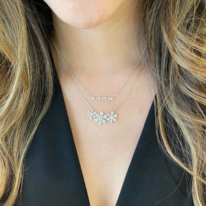 Female model wearing Diamond Daisy Trio Necklace - 14K gold weighing 5.35 grams - 237 round diamonds totaling 0.88 carats