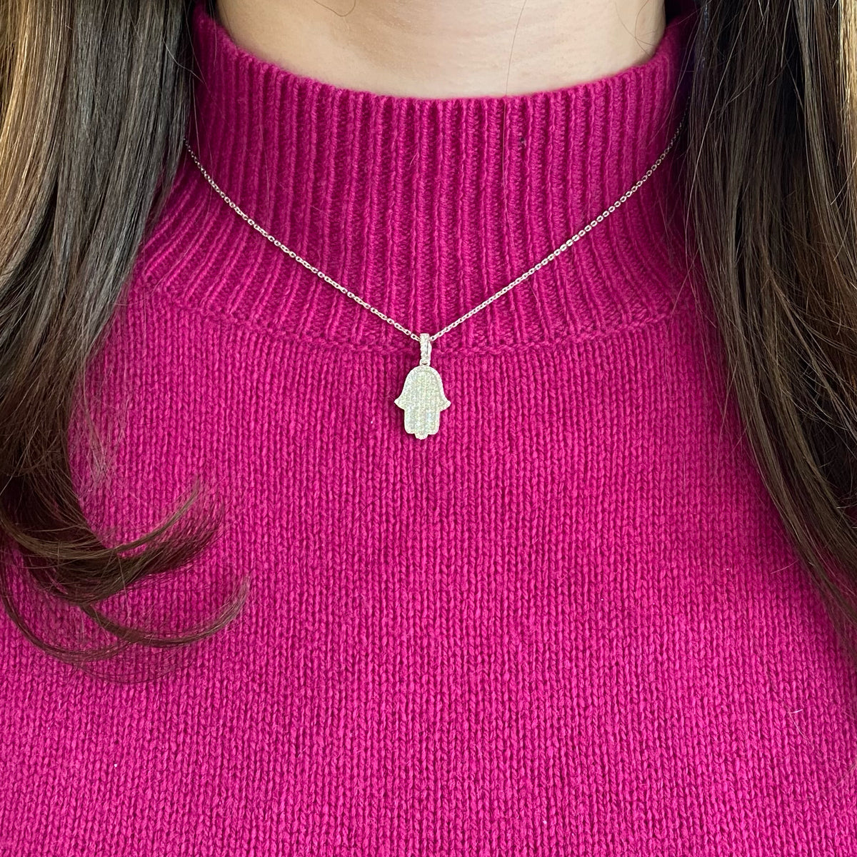 Female Model Wearing Pave Diamond Hamsa Pendant  - 18K gold weighing 2.26 grams  - 14K gold weighing 2.20 grams  - 121 round diamonds totaling 0.50 carats