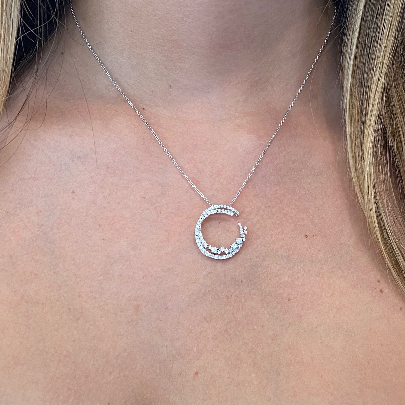 Diamond Overlapping Circles Pendant  - 18K gold weighing 2.64 grams  - 14K gold weighing 1.90 grams  - 66 round diamonds totaling 0.65 carats