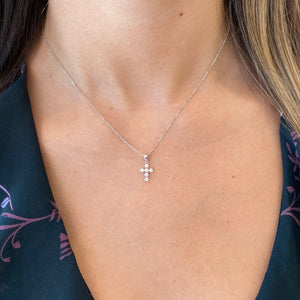 Female Model Wearing Diamond Rounded Cross Pendant  - 14K gold weighing 2.22 grams  - 6 round diamonds totaling 0.15 carats