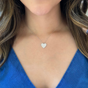 Female Model Wearing Diamond Classic Heart Pendant Necklace  - 14K gold weighing 2.72 grams.  - 130 round diamonds totaling 0.41 carats.