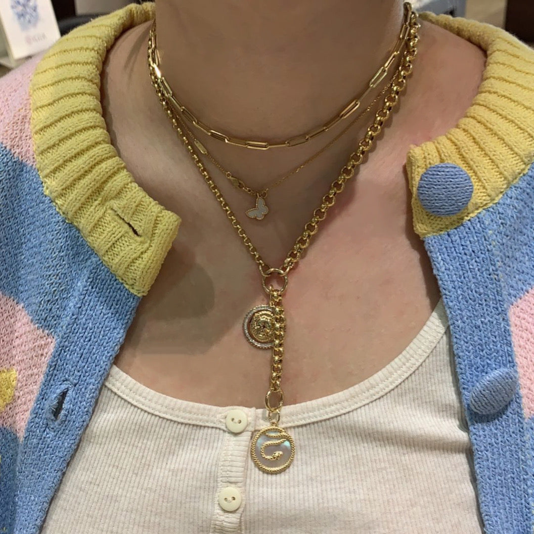 Female model wearing Diamond & Emerald Lion Pendant - 14K yellow gold weighing 4.95 grams - 54 round diamonds totaling 0.15 carats - 2 emeralds totaling 0.01 carats