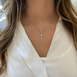 Female Model Wearing Diamond Rounded Cross Pendant  -14K gold weighing 2.84 grams  -21 round prong-set diamonds totaling 0.33 carats