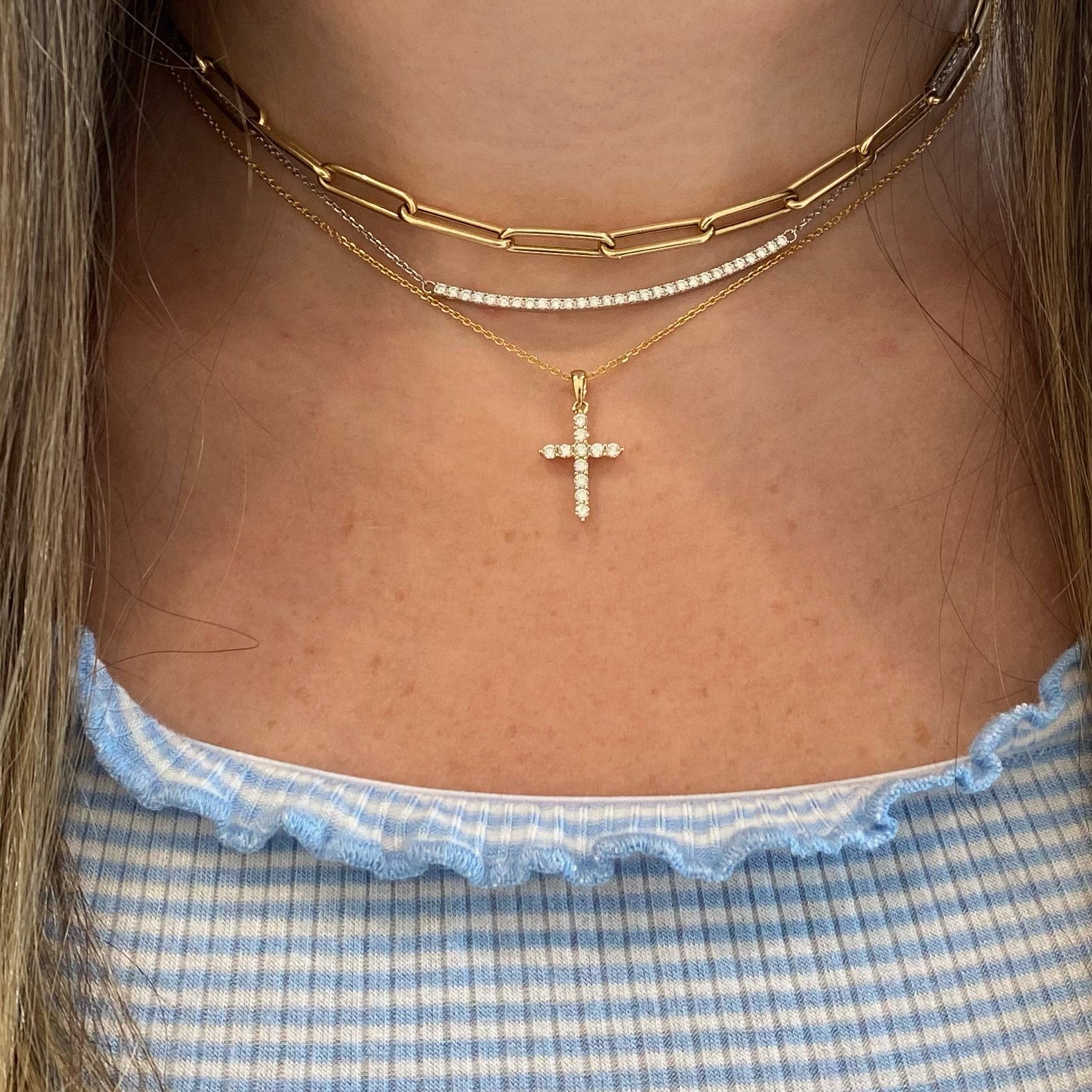 Diamond Slim Cross Pendant  -14K gold weighing 2.35 grams  -11 round shared prong-set brilliant diamonds totaling 0.33 carats.