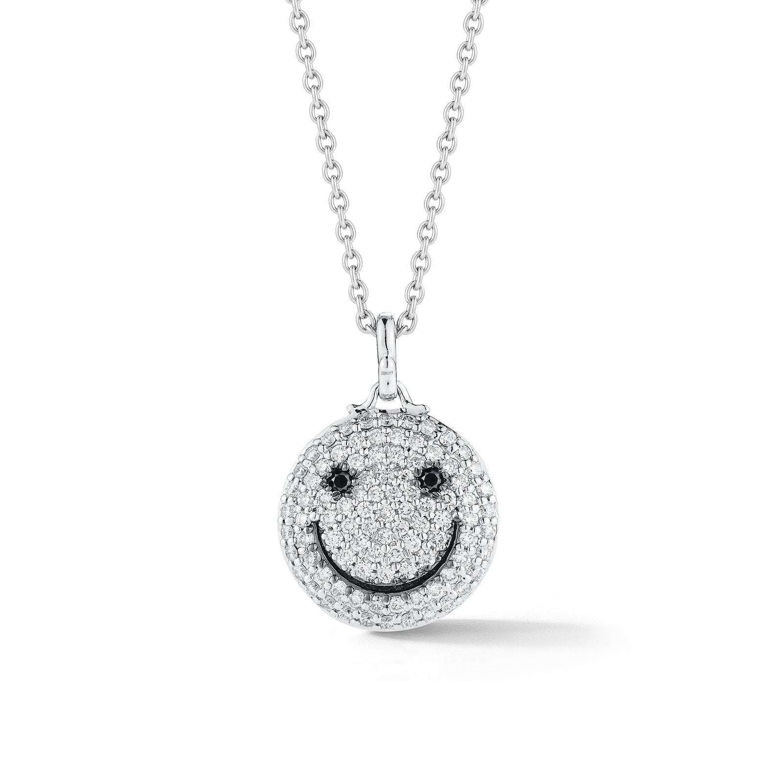Diamond Smile Pendant     - 14k gold weighting 8.80 grams.  - 92 round prong-set diamonds .95 carats, 2 black round prong-set diamonds .06 carats.  Size 17 millimeters diameter.