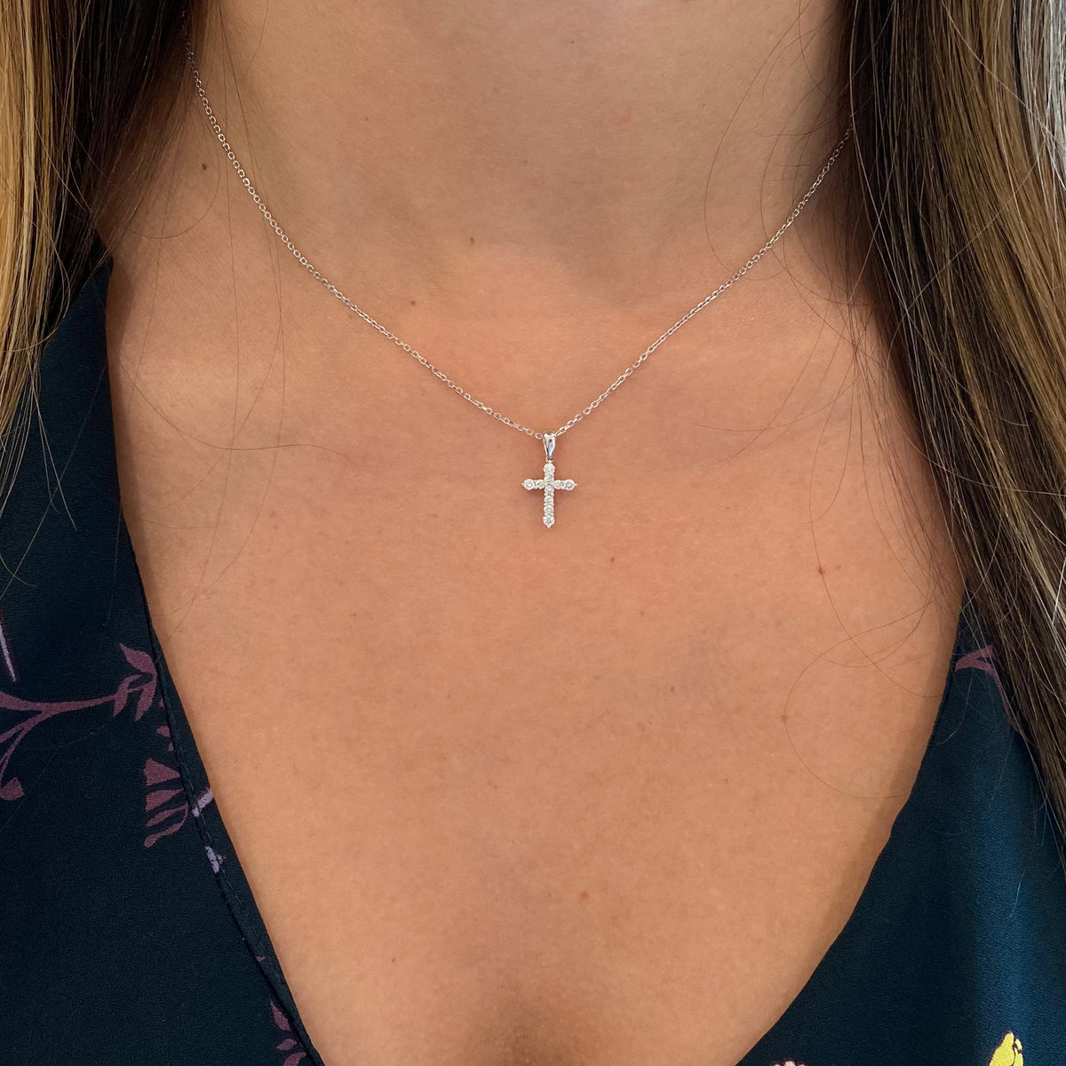 Female  Model Wearing Diamond 10-Stone Small Cross Pendant  - 14K gold weighing 2.20 grams  - 10 round diamonds totaling 0.22 carats