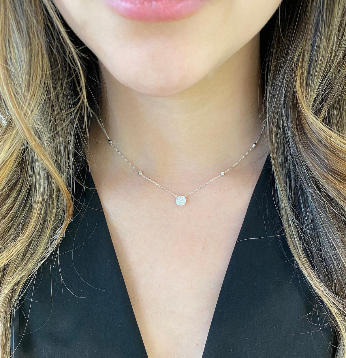 Female Model Wearing Diamond Solitaire with Bezel-Set Diamond Stations  - 18K gold weighing 2.33 grams  - 0.17 ct round diamond  - 13 round diamonds totaling 0.24 carats