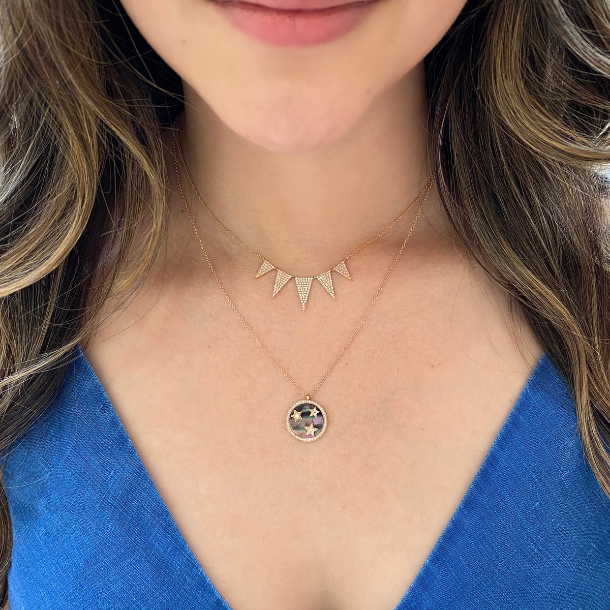 Female Model Wearing Diamond Graduated Triangle Necklace  -14K gold weighing 3.07 grams  -193 round pave-set diamonds totaling 0.57 carats.