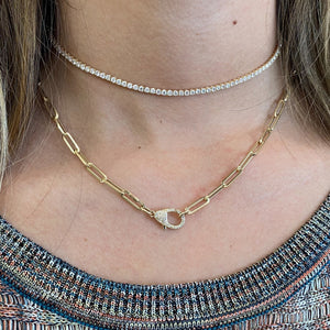 Female model wearing Pave Diamond Oversized Clasp Pendant Necklace - 14K yellow gold weighing 1.36 grams  - 80 round diamonds weighing 0.20 carats.