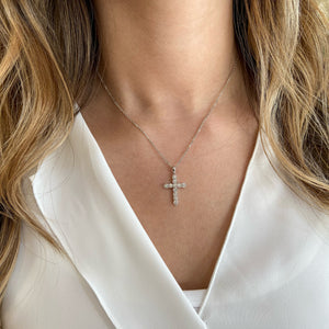 Female Model Wearing Bezel-Set Diamond Cross Pendant with Antique Milgrain  The perfect gift for a christening, communion, confirmation, birthday, or holiday.  -14K gold weighing 3.80 grams  -11 round bezel-set brilliant diamonds k 0.62 carats