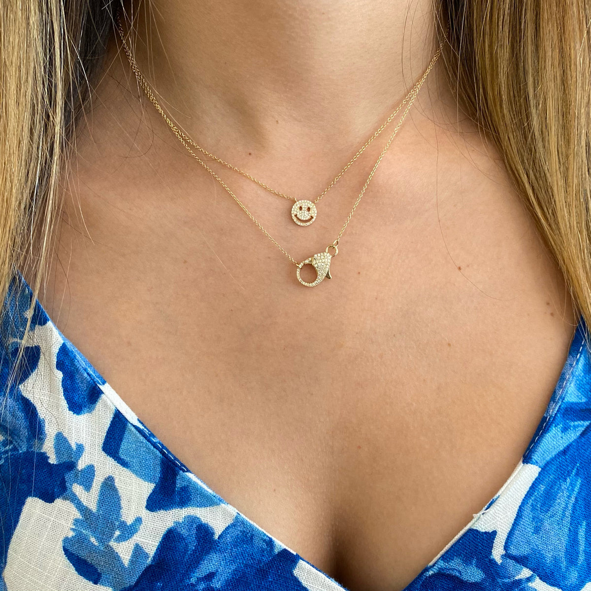 Female Model Wearing Diamond Lobster Claw Pendant  - 14K gold weighing 3.69 grams  - 57 round diamonds totaling 0.20 carats