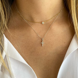 Female Model Wearing Diamond Classic Pointed Cross Pendant Necklace  -14K gold weighing 2.23 grams  -11 round brilliant-cut diamonds totaling 0.15 carats