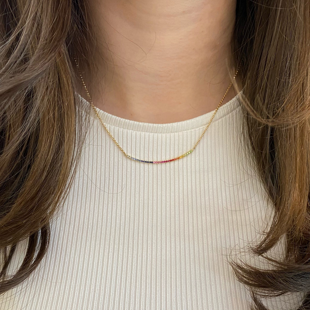 Female Model Wear Rainbow Bar Necklace  -14k gold weighing 3.46 grams  -34 multi-color stones weighing .34 carats