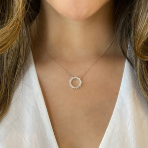 Female Model Wearing Diamond Circle of Life Pendant Necklace  - 14K gold 3.48 grams.  - 18 round diamonds totaling 0.95 carats