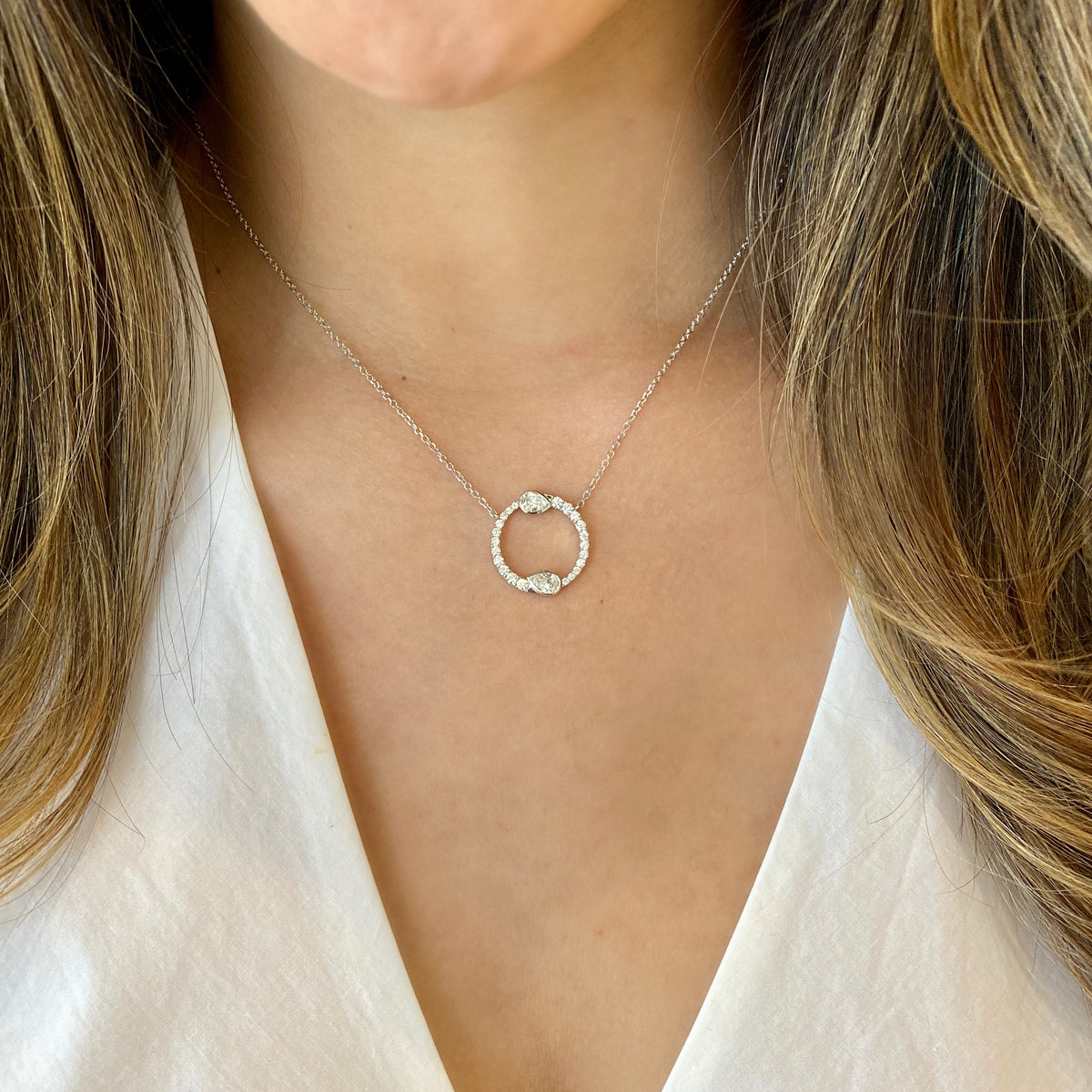 Female Model Wearing Round & Pear-Shaped Diamond Circle Pendant Necklace  -14K gold weighing 3.7 grams  -22 round diamonds totaling 0.43 carats  -2 pear-shaped diamonds totaling 0.58 carats