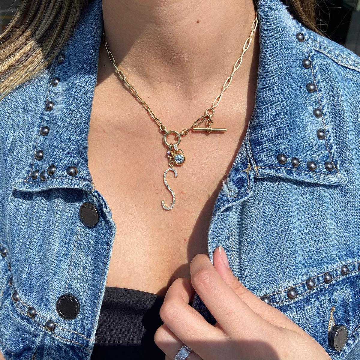 Female model wearing Diamond Bezel Pendant - 14K yellow gold weighing 21.60 grams - 0.64 ct diamond (GIA-graded H color, SI1 clarity)