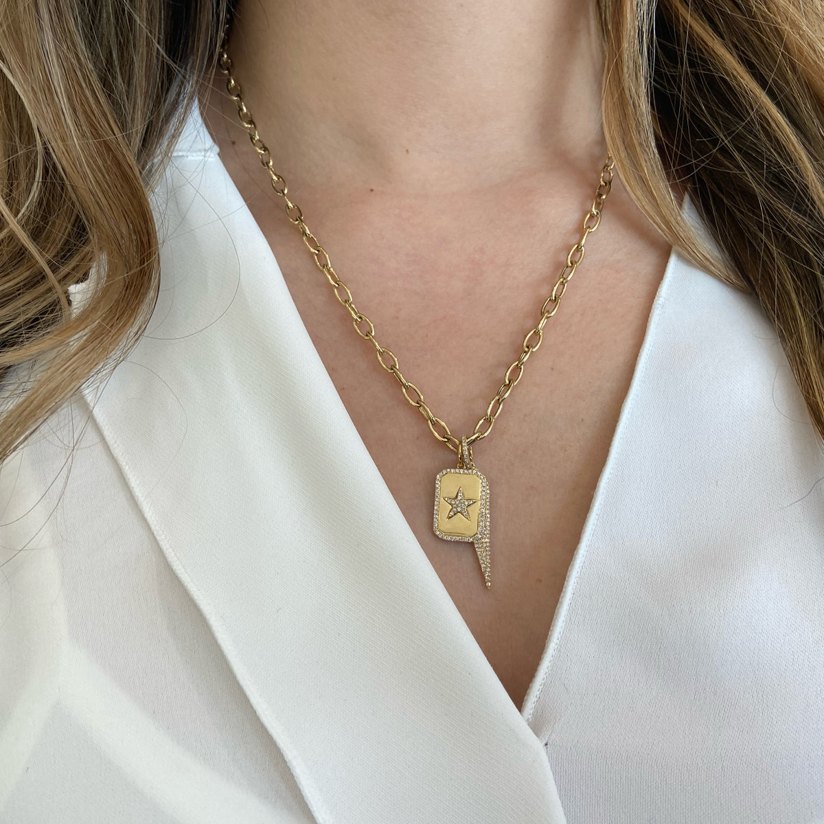 Female Model Wearing Diamond Star Dog Tag Charm  -14K gold weighing 3.35 grams  -72 round diamonds totaling 0.19 carats