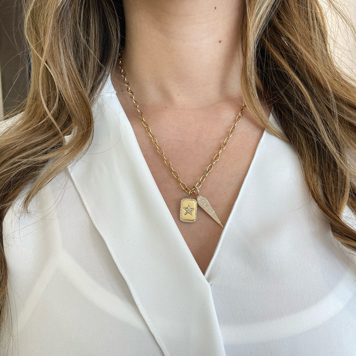 Female Model Wearing Diamond Star Dog Tag Charm  -14K gold weighing 3.35 grams  -72 round diamonds totaling 0.19 carats