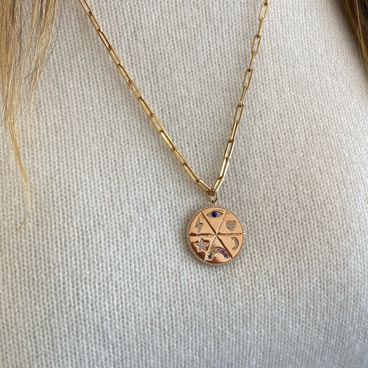 Female model wearing Diamond & Multicolor Gemstone Lucky Symbols Large Disc Pendant - 14K gold weighing 8.48 grams - 122 round diamonds totaling 0.34 carats - 7 multicolor gemstones totaling 0.22 carats.