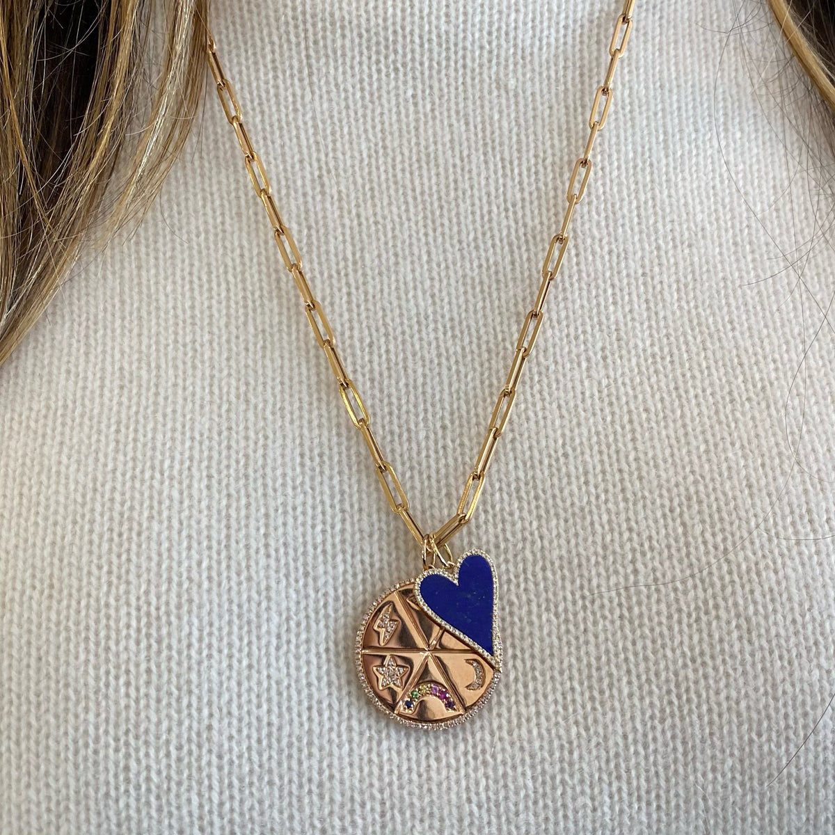 Female model wearing Diamond & Multicolor Gemstone Lucky Symbols Large Disc Pendant - 14K gold weighing 8.48 grams - 122 round diamonds totaling 0.34 carats - 7 multicolor gemstones totaling 0.22 carats. Available in yellow, white, and rose gold.