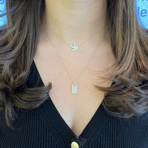 Female model wearing Pave Diamond Dog Tag Necklace with Diamond Bail  - 14K gold weighing 2.88 grams  - 168 round diamonds totaling 0.38 carats