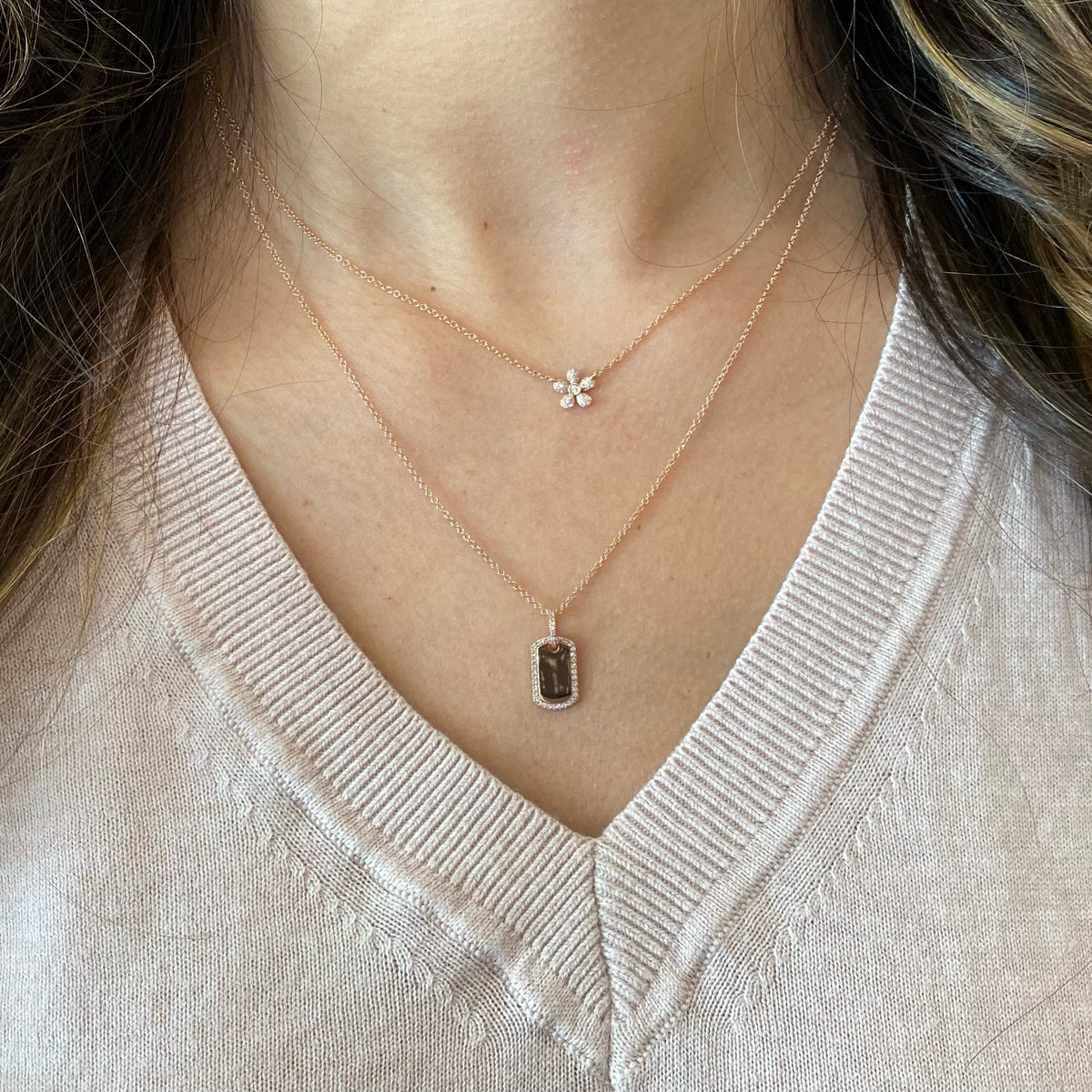 Female model wearing Diamond Dog Tag Pendant - 14K yellow gold weighing 2.72 grams  - 43 round diamonds weighing 0.09 carats