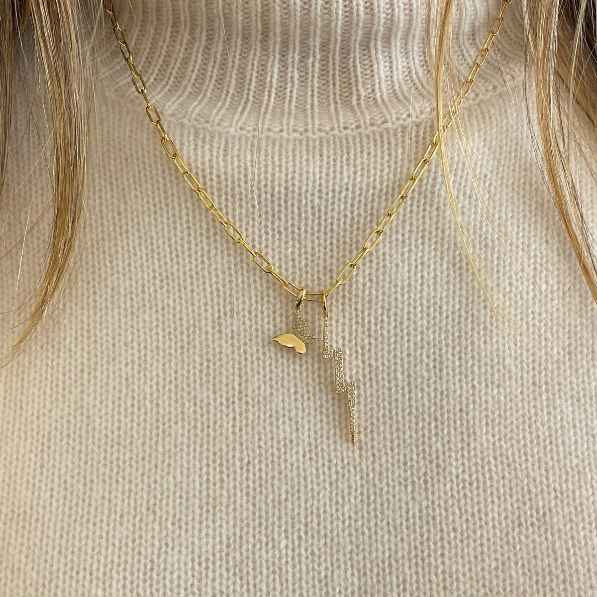 Female model wearing Diamond Butterfly Charm - 14K gold weighing 0.88 grams - 33 round diamonds totaling 0.08 carats