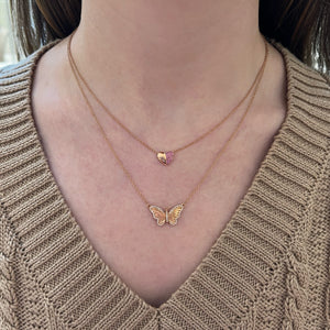 Female model wearing Diamond Wide Butterfly Pendant - 14K gold weighing 2.54 grams - 58 round diamonds totaling 0.17 carats