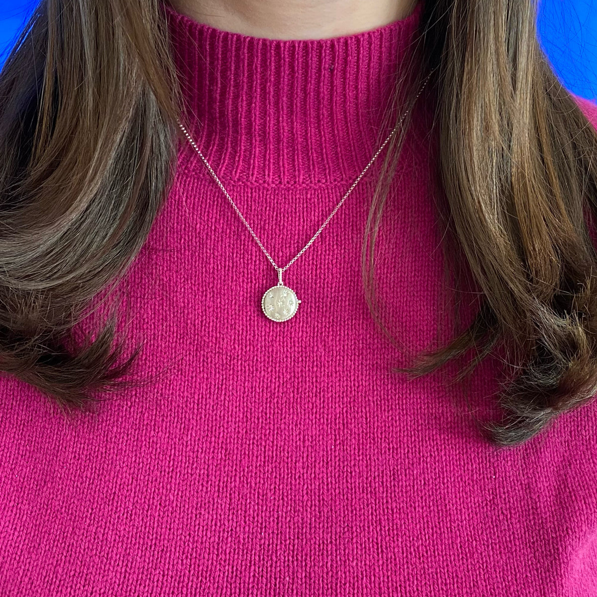 Female Model Wearing Diamond Star Locket Necklace  -14K gold weighing 5.24 grams  -15 round diamonds totaling 0.12 carats