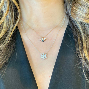 Female model wearing Pave Diamond Daisy Pendant Necklace  -14K gold weighing 2.42 grams  -103 round pave-set diamonds totaling 0.32 carats