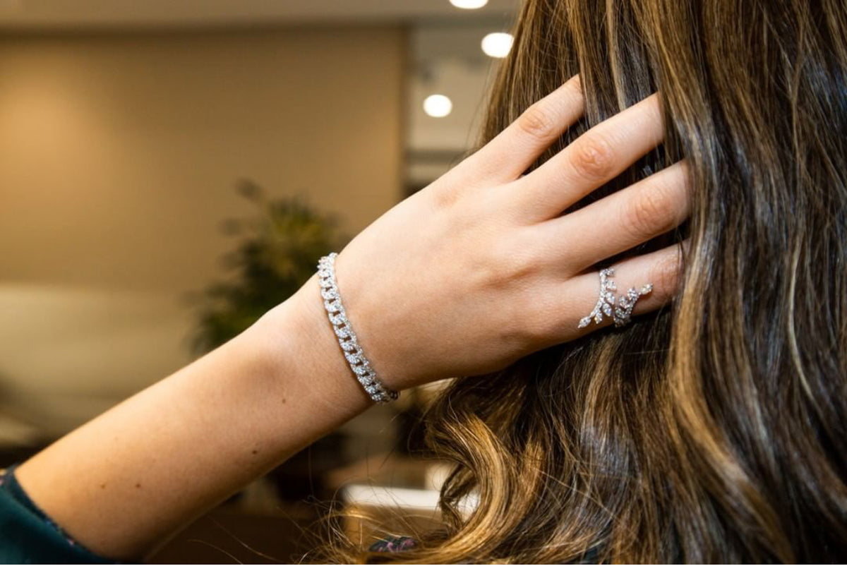 Female model wearing Diamond Small Link Cuff Bracelet -14K gold weighing 13.86 grams -153 round diamonds totaling 1.64 carats