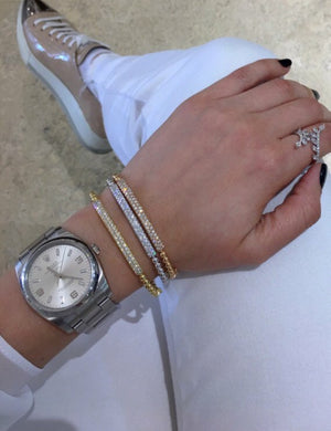 Female Model Wearing Diamond Bar Beaded Bangle Bracelet  -14K gold weighing 9.69 grams  -50 round pave-set diamonds totaling 0.88 carats.